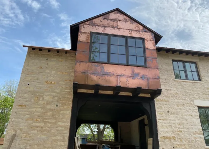 Copper metal panel facade on a stone building for Skylight Installation in Rockton